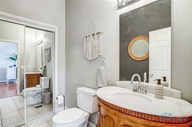 bathroom with vanity, tile patterned floors, and toilet