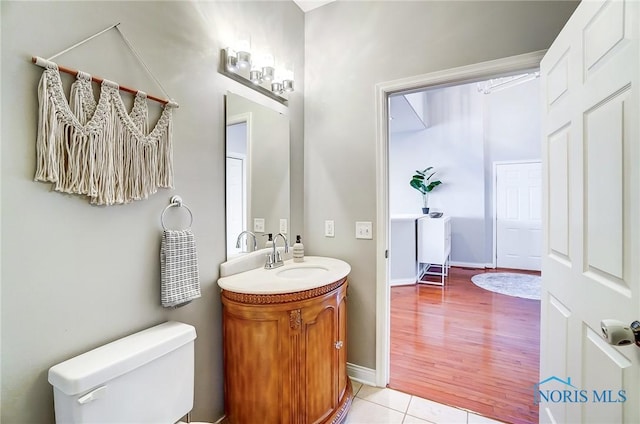 bathroom featuring tile patterned floors, vanity, and toilet