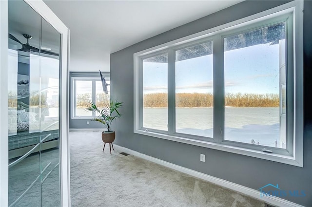 doorway to outside featuring carpet flooring