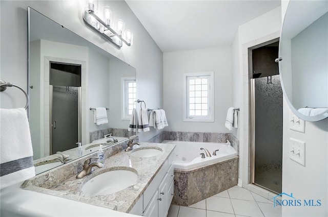 bathroom featuring tile patterned floors, independent shower and bath, and vanity