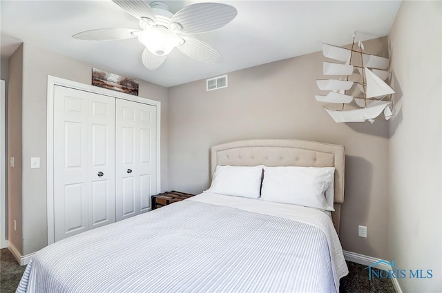 carpeted bedroom featuring a closet and ceiling fan