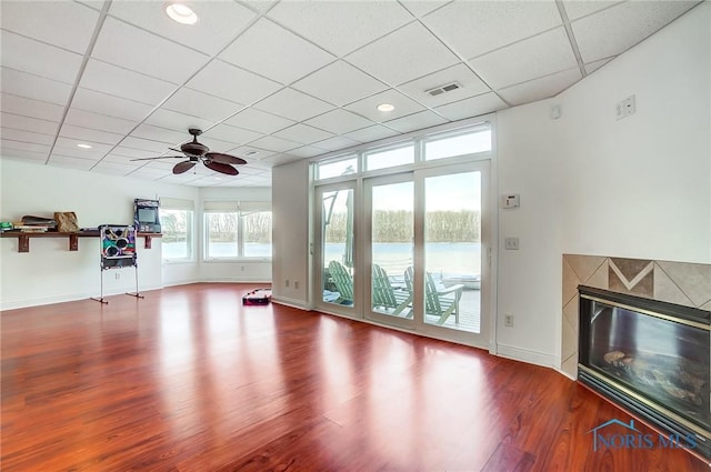 interior space with a premium fireplace, a paneled ceiling, hardwood / wood-style floors, and ceiling fan