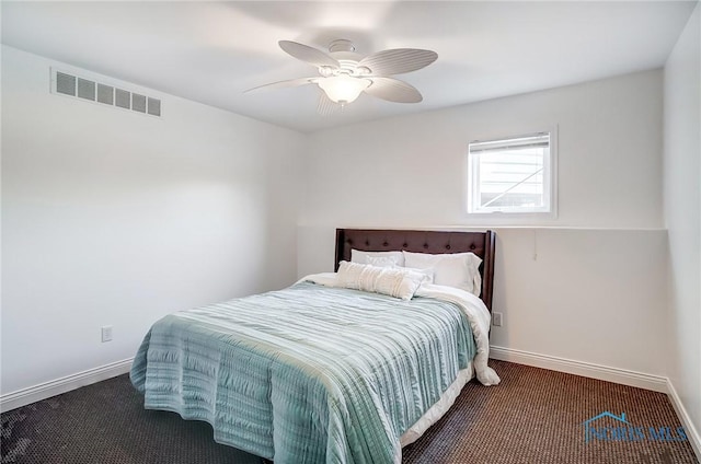 bedroom featuring ceiling fan and dark carpet