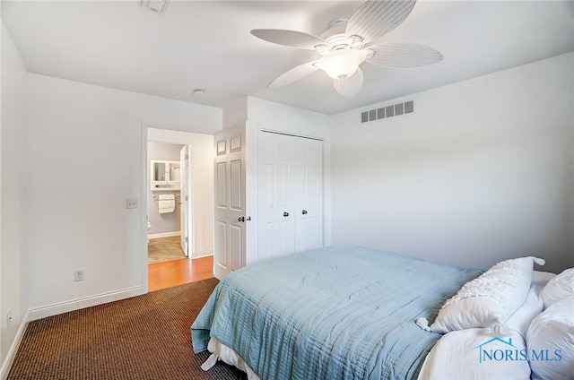 carpeted bedroom with ceiling fan and a closet