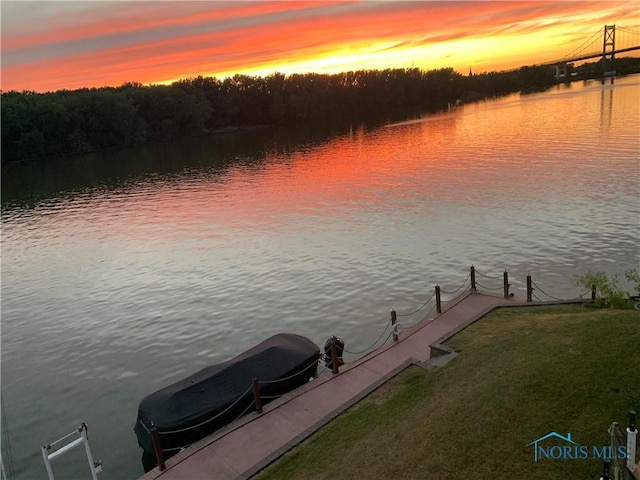 dock area featuring a water view and a lawn