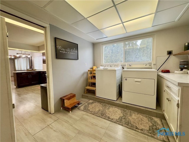 clothes washing area with separate washer and dryer