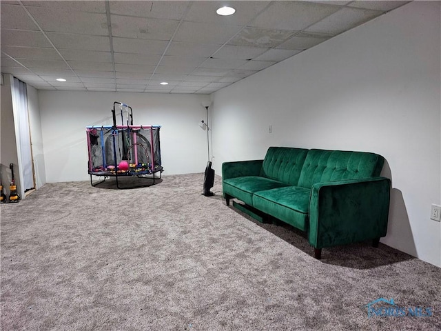 interior space featuring carpet floors and a paneled ceiling