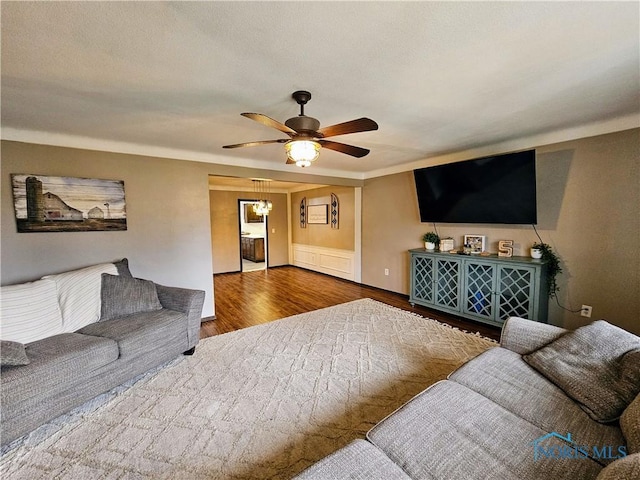 living room with hardwood / wood-style flooring and ceiling fan