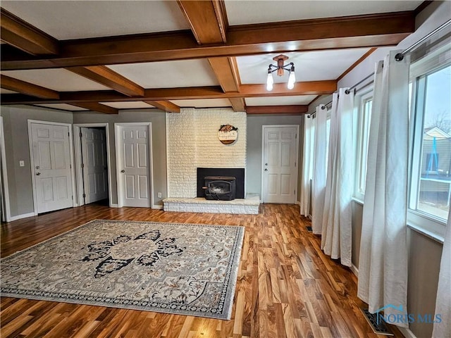 living room featuring wood-type flooring, coffered ceiling, and beam ceiling