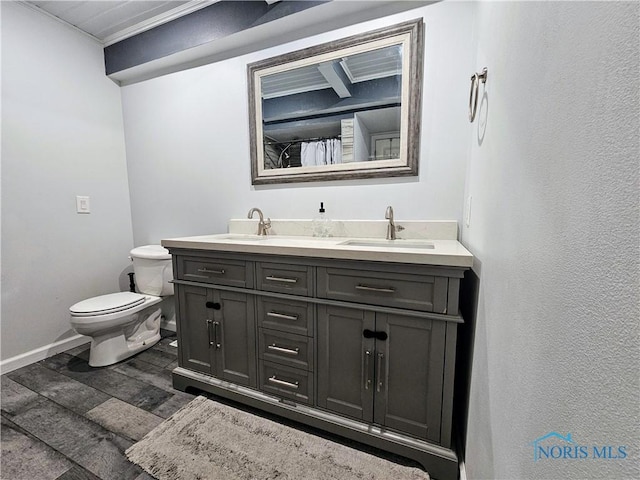 bathroom with vanity, hardwood / wood-style floors, and toilet