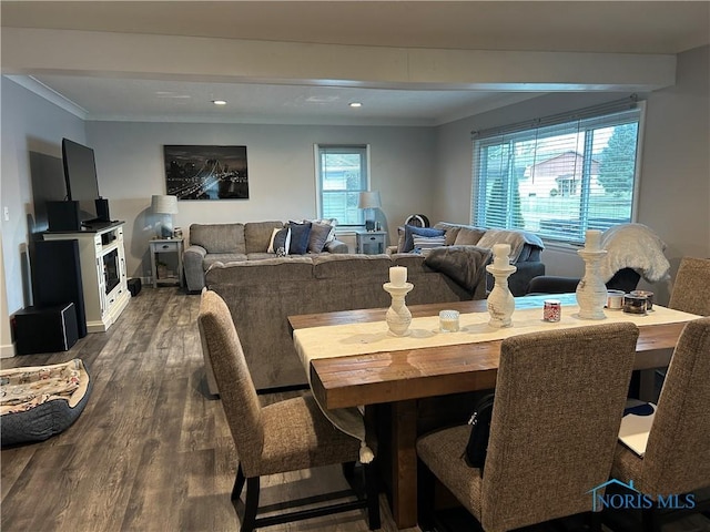 dining room featuring crown molding and dark wood-type flooring