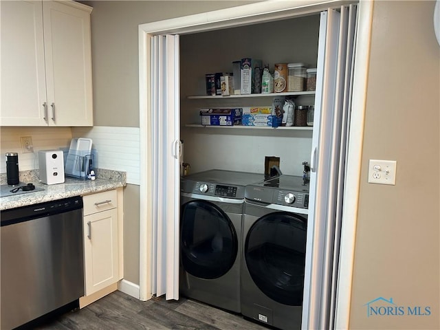 clothes washing area with dark wood-type flooring and washer and dryer