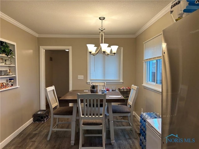 dining space featuring an inviting chandelier, ornamental molding, and dark hardwood / wood-style flooring