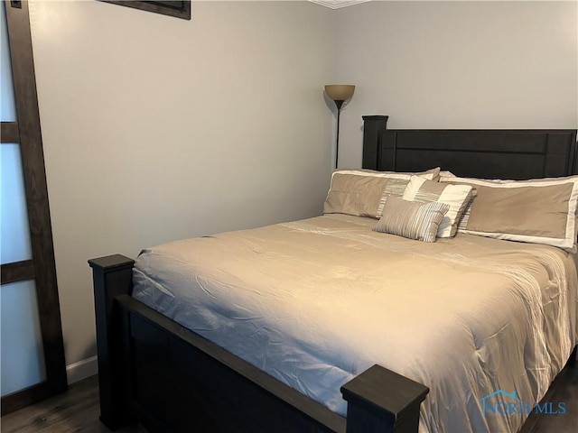 bedroom featuring dark hardwood / wood-style flooring