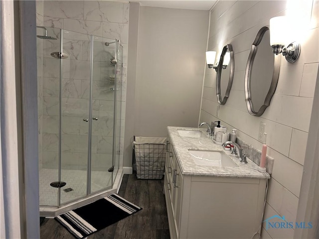 bathroom with vanity, wood-type flooring, and an enclosed shower