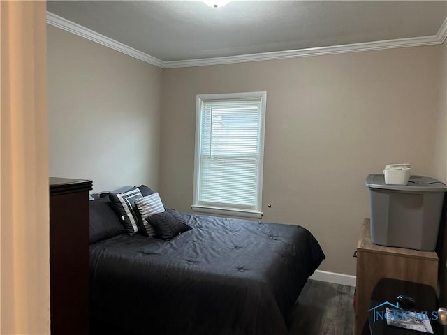 bedroom featuring crown molding and dark wood-type flooring