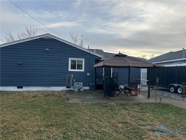 back of property featuring a gazebo, a yard, and a patio area