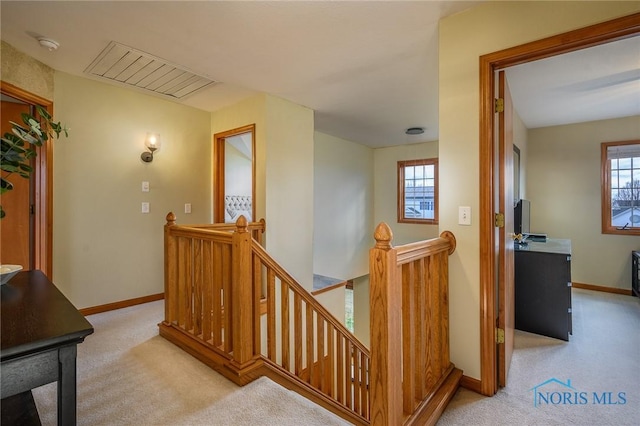 stairs featuring plenty of natural light and carpet flooring