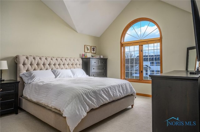 carpeted bedroom featuring lofted ceiling