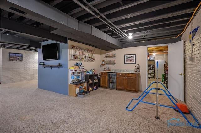 basement featuring light colored carpet, brick wall, bar area, and beverage cooler