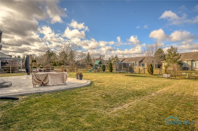 view of yard with a playground, a patio area, and a trampoline