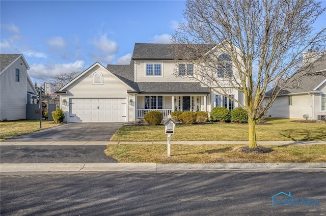 view of front of home with a garage and a front lawn