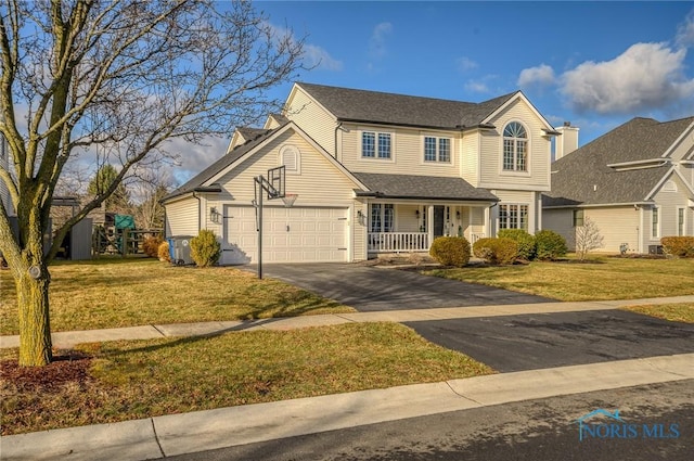 view of front facade with a garage and a front yard