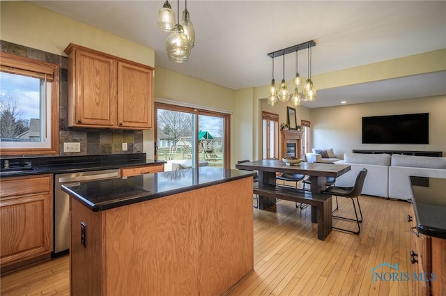 kitchen with pendant lighting, a center island, light hardwood / wood-style floors, and dishwasher