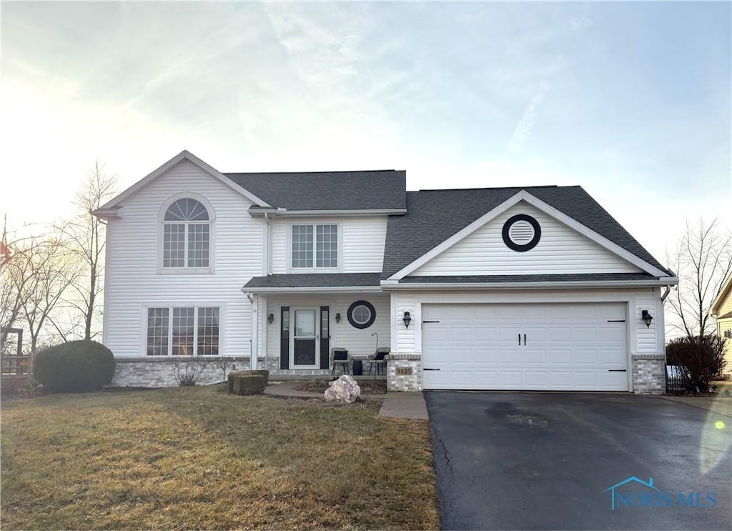 view of front of home featuring a garage and a front yard