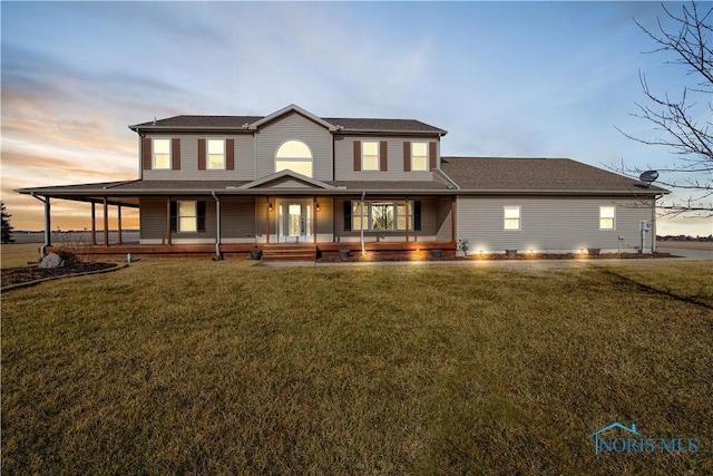 country-style home featuring a porch and a yard