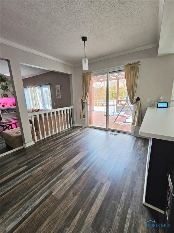 living room with ornamental molding, dark hardwood / wood-style floors, and a textured ceiling