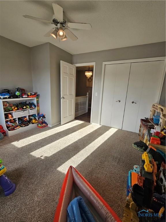 bedroom with carpet flooring, ceiling fan, and a closet