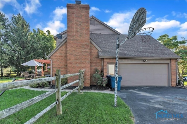 view of side of home with a garage and a yard