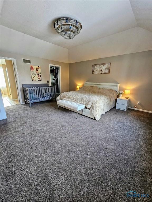 bedroom featuring carpet flooring and vaulted ceiling