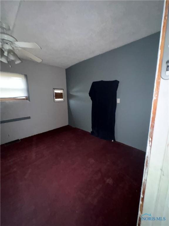 unfurnished room with carpet and a ceiling fan