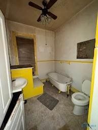 bathroom featuring toilet, ceiling fan, and vanity