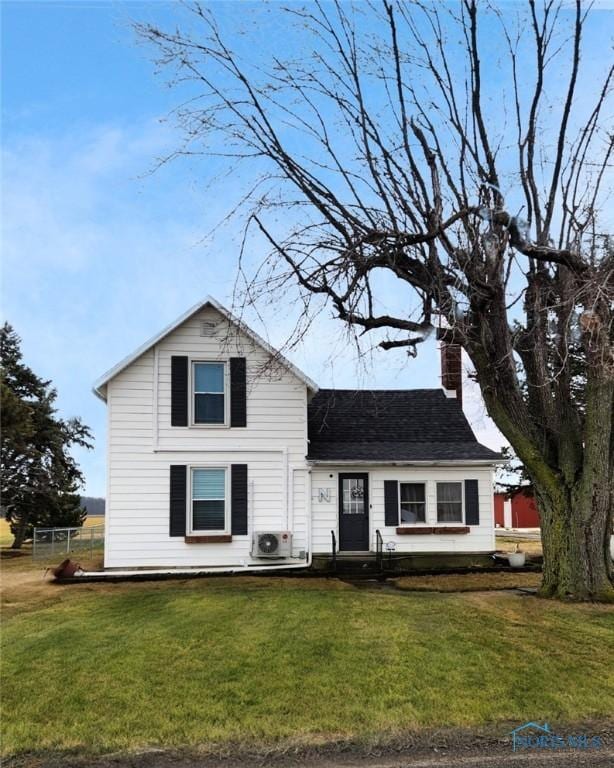 view of front of home featuring a front yard and ac unit