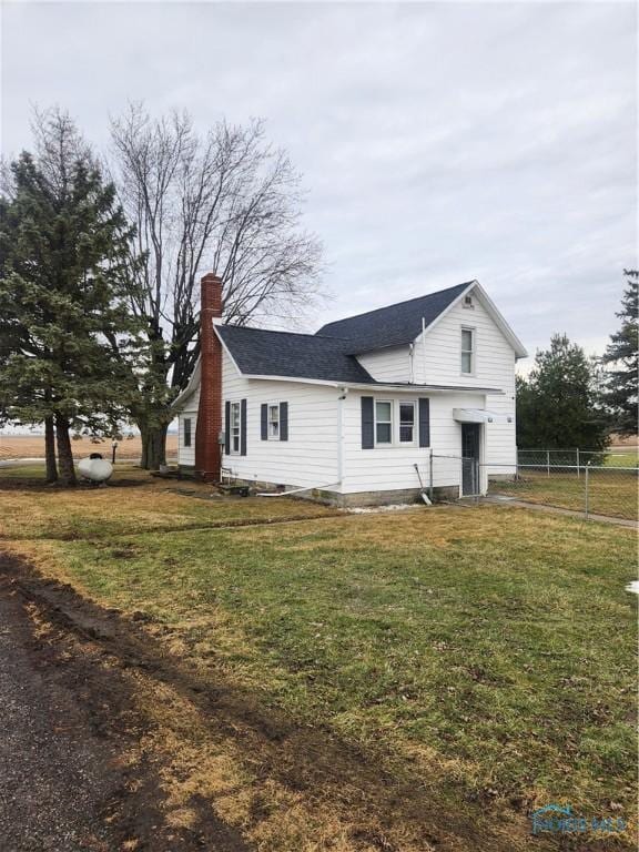 view of side of property with a yard