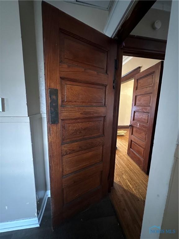 hallway with dark wood-type flooring