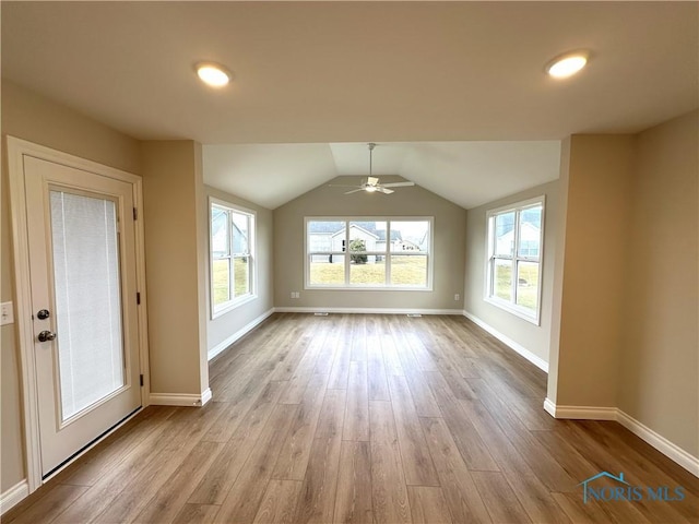 interior space with ceiling fan, lofted ceiling, and light hardwood / wood-style floors