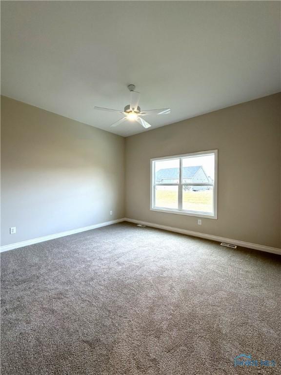 carpeted empty room with ceiling fan