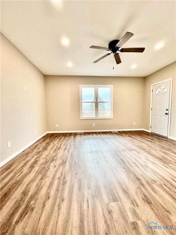 unfurnished room featuring ceiling fan and light wood-type flooring