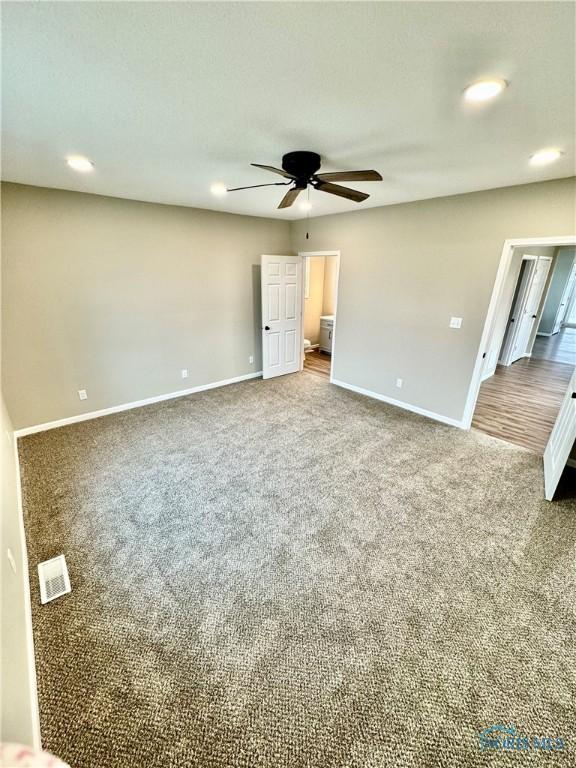 unfurnished bedroom with ceiling fan and carpet