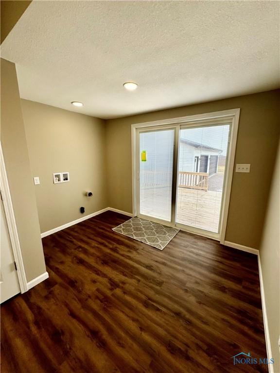 laundry area with hookup for a washing machine, dark hardwood / wood-style floors, and a textured ceiling