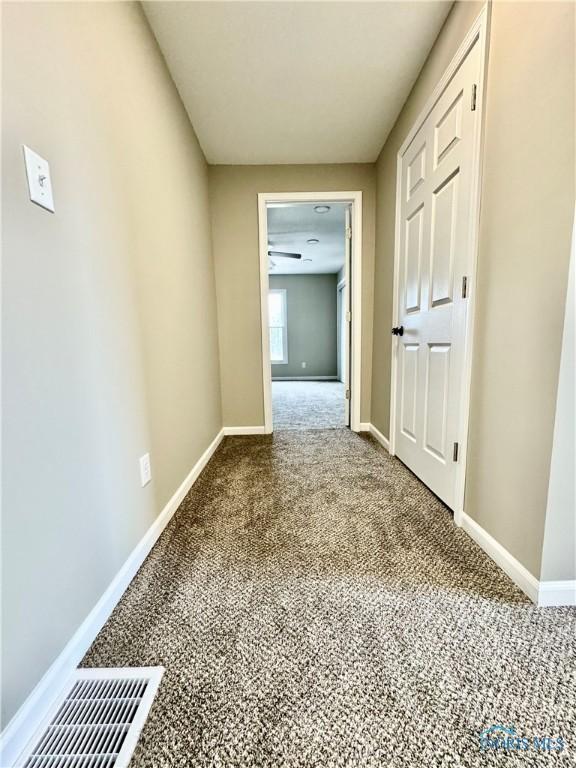 corridor featuring carpet flooring