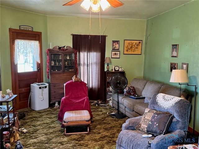 carpeted living room featuring ceiling fan