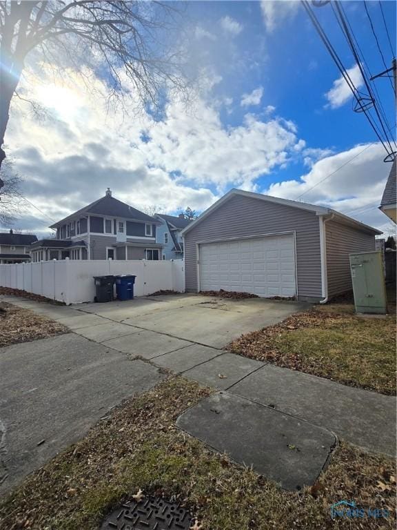 exterior space with a garage and an outbuilding