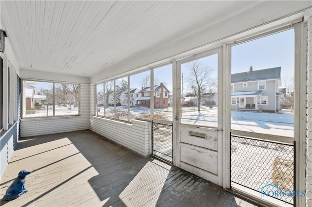 unfurnished sunroom featuring wood ceiling