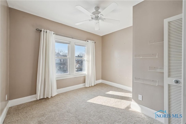 unfurnished room featuring light carpet and ceiling fan