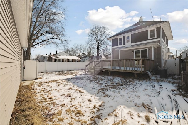 snow covered property featuring a wooden deck